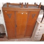 A 1.18m 20th Century oak and mixed wood wardrobe with reversed mirror plate to central door