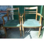 A pair of 20th Century Meredew Avalon stained wood framed elbow chairs with green velour upholstered