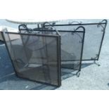 Three wrought iron and mesh fire guards