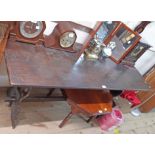 A 1.53m 20th Century stained oak refectory style dining table, set on shaped and pierced standard