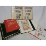 Four albums containing mainly hinge mounted 20th Century world stamps - sold with another containing