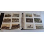 A blue album containing a collection of sleeve mounted mainly early 20th Century postcards,