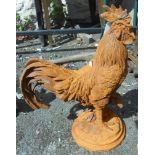 An iron garden cockerel with rusted finish