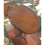 A 1.08m diameter reproduction mahogany pedestal table, set on turned pillar and quadruple reeded