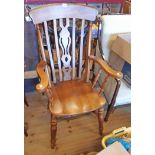 A Novoles stained wood Windsor style high back elbow chair with moulded sectional seat, set on