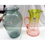 A glass vase and a decorative jug