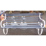A 1.68m painted wrought iron and slatted wood garden bench, set on scroll ends
