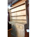 A 2.13m Victorian stripped pine two part dresser with three shelf open plate rack over a base with