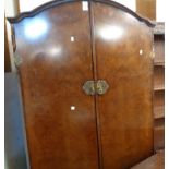 A 1.11m mid 20th Century figured walnut veneered break dome-top double wardrobe with fitted interior