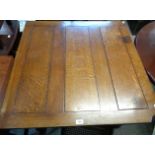 A 91cm 20th Century stained oak draw-leaf dining table with panelled top, set on heavy barley