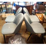 A set of four modern retro design curved back standard chairs with quilted grey upholstery, set on