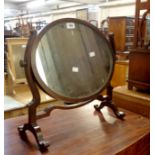 An Edwardian stained mixed wood dressing table mirror with oval plate, set on slender shaped
