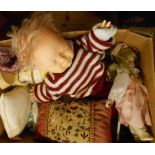 A box containing dolls and assorted textiles, etc.