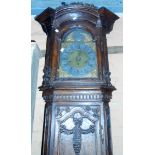 A 19th Century French provincial ornate carved oak longcase clock with glazed aperture to door,