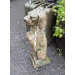 A concrete garden statue in the form of a seat dog