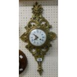 A 19th Century French ornate cast brass cased cartel wall clock with mask and scroll decoration, the