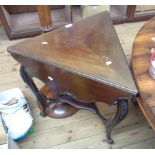 An Edwardian walnut triangular drop-leaf centre table with carved and moulded edge, slender acanthus