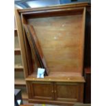 A 1.32m 20th Century pine and mixed wood five shelf open bookcase with double cupboard under, set on