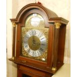 A 20th Century reproduction mahogany longcase clock, the 30cm arch dial marked for retailer