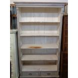 A 1.13m shabby chic pine five shelf open bookcase with moulded cornice, flanking decoration and