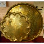 A large eastern brass tray with central calligraphy - sold with another similar