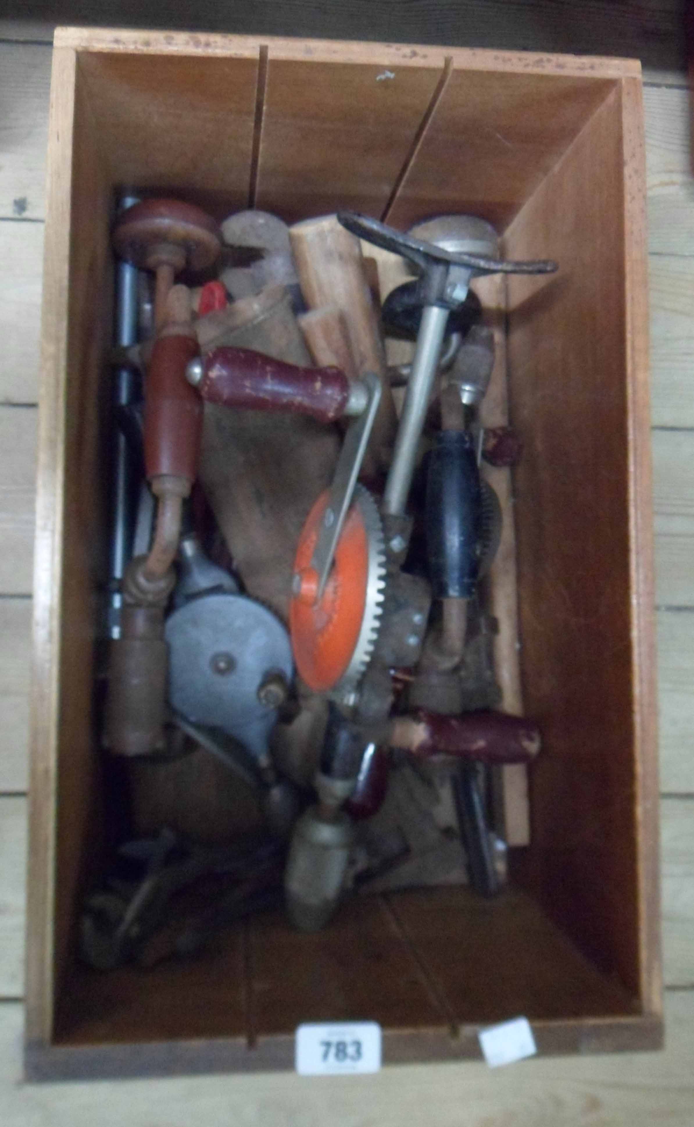 A drawer containing assorted tools including brace and bit, adjustable spanners, etc.