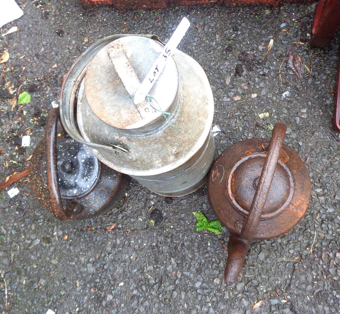 A galvanised metal dairy churn - sold with two cast iron kettles