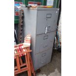 A vintage grey metal painted three drawer filing cabinet