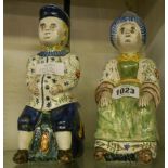 A pair of 19th Century French faience lidded figural jugs in the Dutch Delft style - a/f