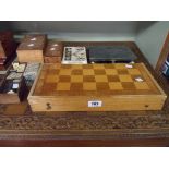 Two vintage wooden chess sets, dominoes, patience cards, draughts, a folding board and a carved wood