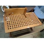 A 1.05m retro polished hardwood coffee table with pierced lattice top and shaped standard ends