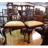 A pair of Chippendale style mahogany framed standard chairs with ornate pierced ribbon splat backs
