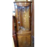 A 65cm reproduction yew corner cabinet with glazed door to top, canted sides and cupboard door