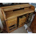 A 1.38m mid 20th Century Angus of London oak roll-top desk with drawer fitted interior, central