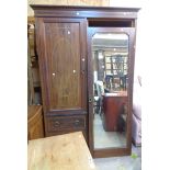 A 1.33m Edwardian inlaid mahogany double wardrobe with hanging space enclosed by a bevelled mirror