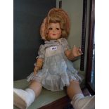 A vintage crying doll with original clothes