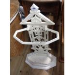 A late Victorian Aesthetic style cast iron umbrella stand with original drip tray and later