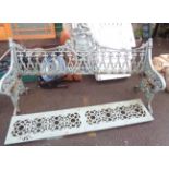 A 1.79m old painted cast iron Gothic style garden bench with heraldic back, flanking shaped ends and