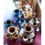Ten Torquay pottery tulip or udder vases including Longpark, Aller Vale, Barton, Lemon & Crute,