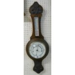 An early 20th Century stained oak cased banjo thermometer/barometer with printed dial, scale and