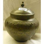 An oriental bronze pot and lid