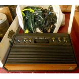 A late 1970's - early 1980's Atari Video Computer System console with two joysticks, two paddles,
