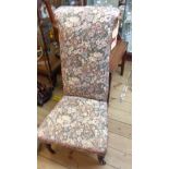 A Victorian prie dieu chair with later floral tapestry upholstery, set on turned front legs and