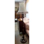 A vintage stained wood standard lamp with circular petal base and shade