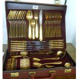 An attaché case containing a twelve place setting of SBS, Solingen ornate gold plated cutlery - as