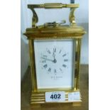 An ornate brass and bevelled glass cased carriage clock with dial marked Hy E. Bedford, Paris,