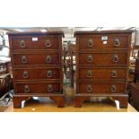 A pair of 43cm reproduction figured walnut bedside chests of four drawers, set on bracket feet - a/