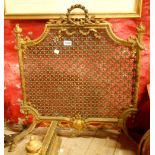 A late Victorian gilt brass firescreen decorated in the Rococo style with reticulated screen