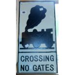 A modern reproduction painted cast iron Crossing No Gates sign