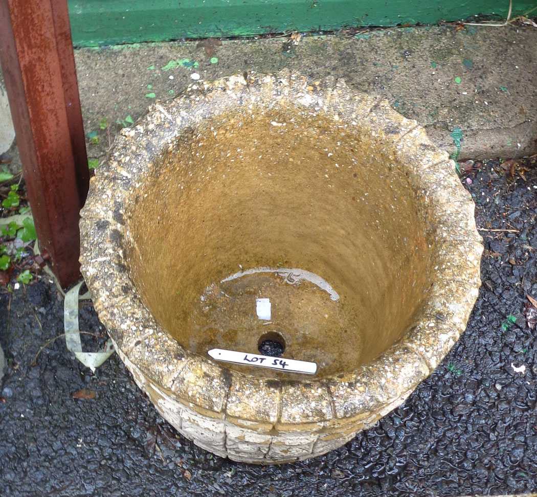 A 39cm diameter concrete garden planter with barrel style decorated sides